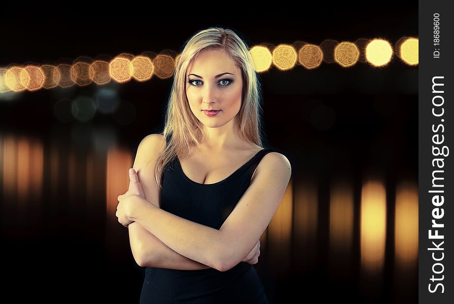 Portrait of beauty blonde girl on black background with night lights, a bit effect cross process. Portrait of beauty blonde girl on black background with night lights, a bit effect cross process