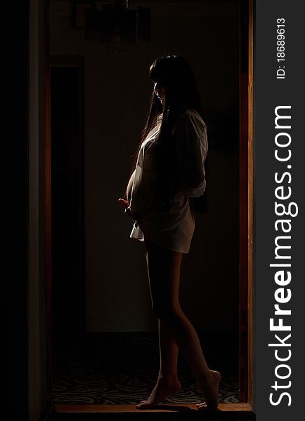 Asian pregnant woman in the dark room. Asian pregnant woman in the dark room