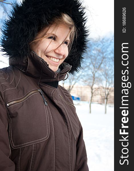 Portrai of beautiful smiling young girl in winter park. Portrai of beautiful smiling young girl in winter park