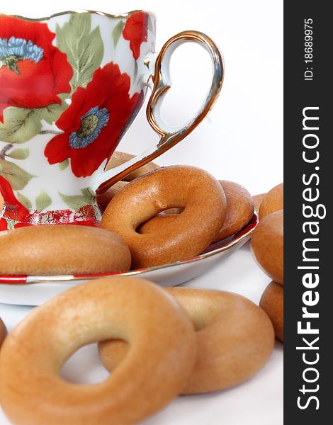 Cup of tea with bagels on a white background