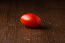 Single Cherry Tomato On Wood Table Royalty Free Stock Image Single Cherry Tomato On Wood Table Royalty Free Stock Image