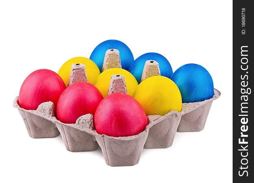 Bright multi-colored eggs in cells on a white background