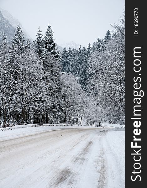 Difficult conditions of mountain road during a snowfall. Difficult conditions of mountain road during a snowfall.