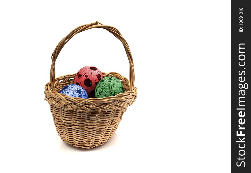 Three coloured quail eggs in a basket. Three coloured quail eggs in a basket