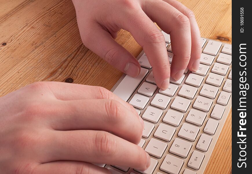 Man typing on a computer keyboard. Man typing on a computer keyboard