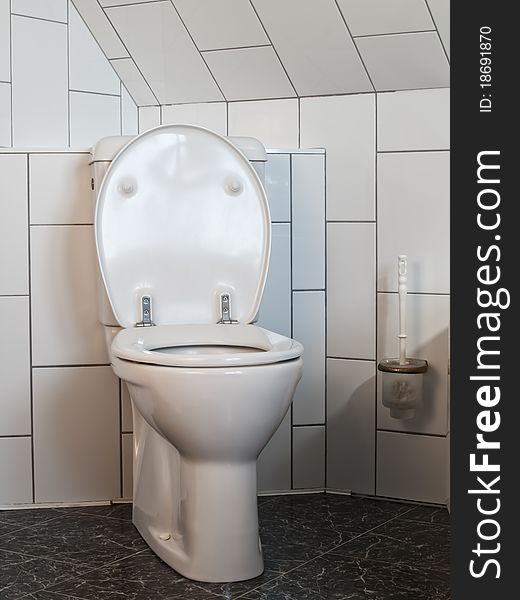 Luxurious toilet in a bathroom with white and black wall tiles. Luxurious toilet in a bathroom with white and black wall tiles
