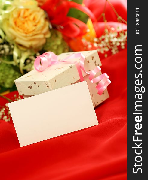 Blank card, gift and flowers on red, holiday background. Blank card, gift and flowers on red, holiday background