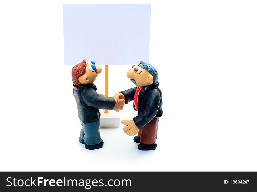 Shot of two plasticine businessmen shaking their hands. Isolated over white background. Shot of two plasticine businessmen shaking their hands. Isolated over white background.
