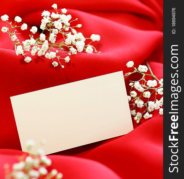 Greeting card with white flowers on red background