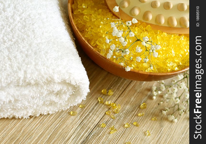 Spa composition of yellow bath salts and towel. Spa composition of yellow bath salts and towel