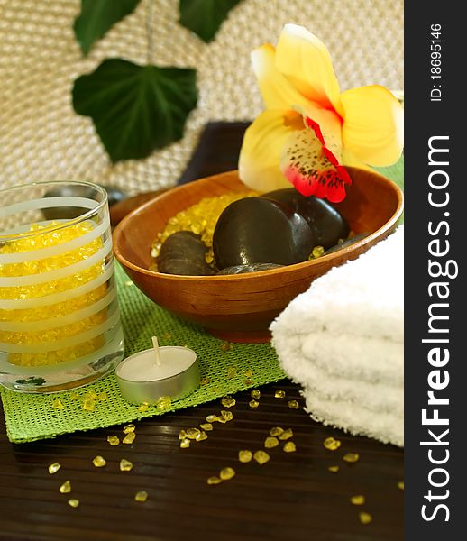 Spa composition of white towel, stones and candle