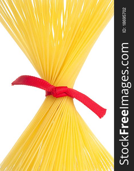 Bunch of spaghetti tied up with red ribbon isolated on white