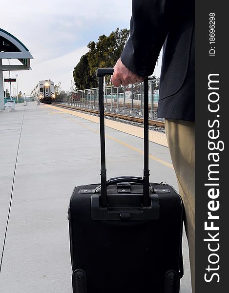 Man on platform waiting for train