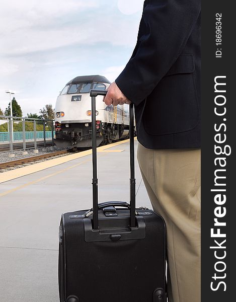 Man on platform waiting for train