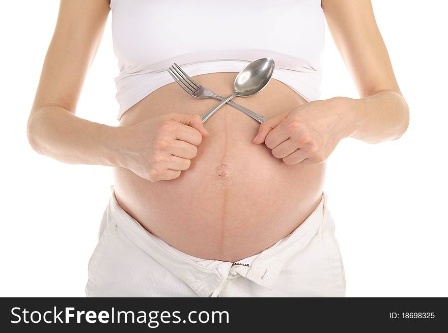 Stomachs of pregnant women with a spoon and fork isolated on white