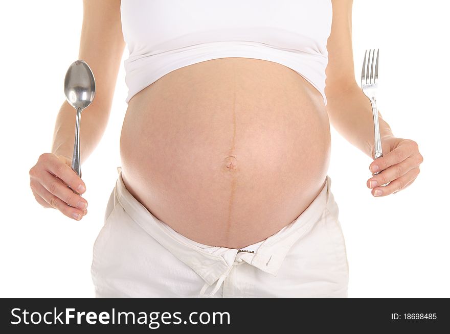 Stomachs of pregnant women with a spoon and fork isolated on white