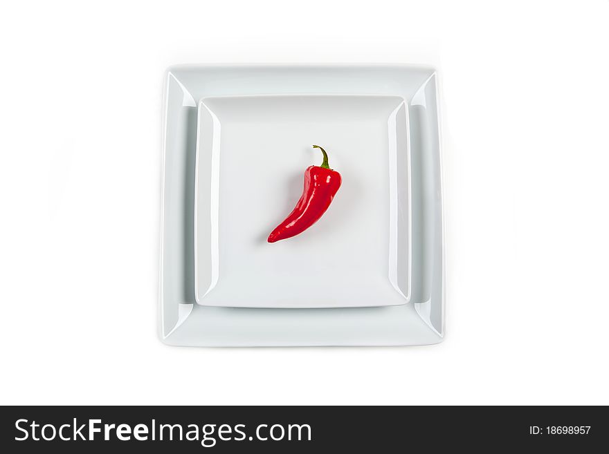Red Pepper on a salad plate against a large white background. Red Pepper on a salad plate against a large white background