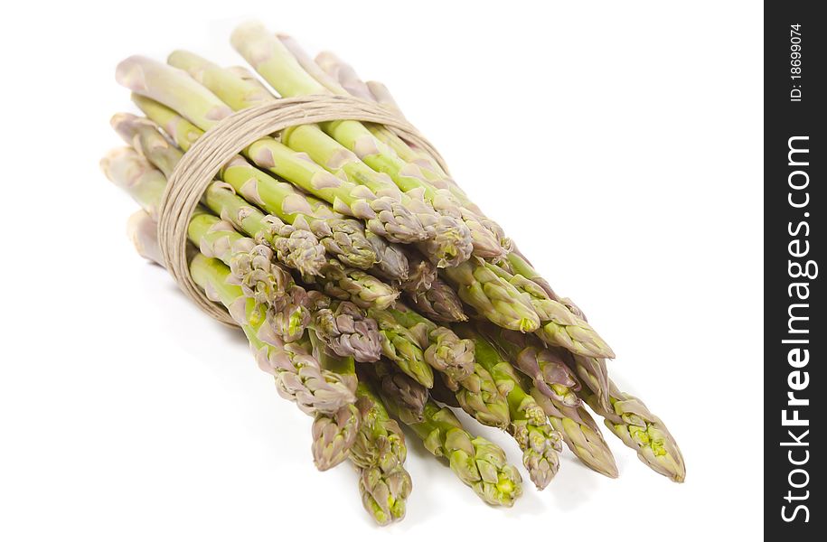 Several stalks of asparagus wrapped in hemp laying on its side. Several stalks of asparagus wrapped in hemp laying on its side.