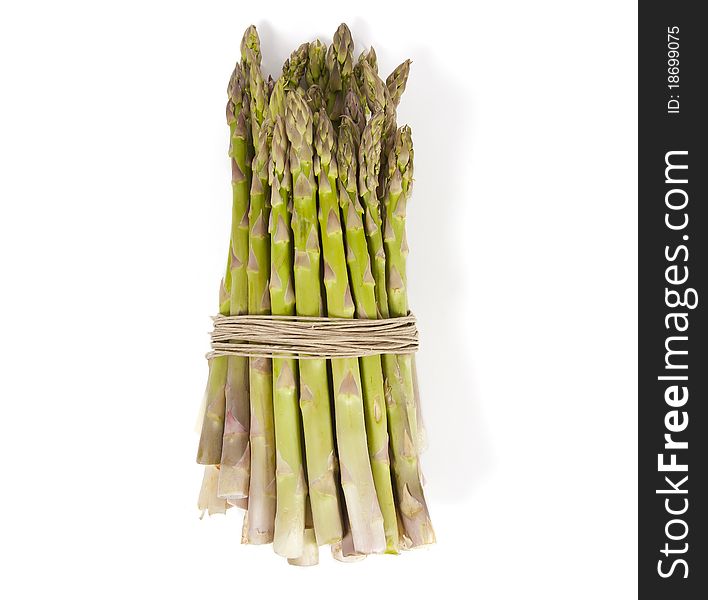 Asparagus wrapped in hemp laying on its side.