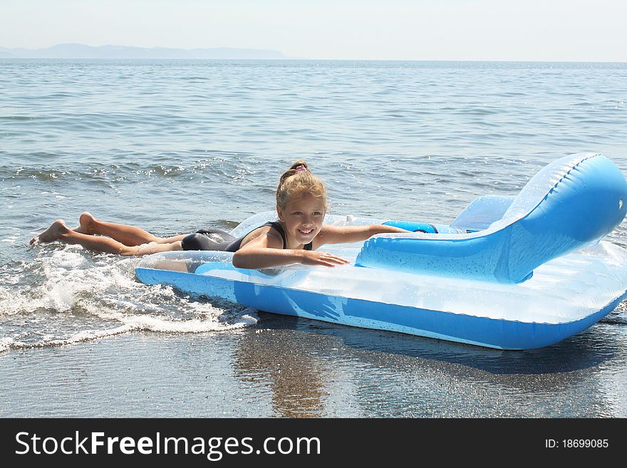 Girl of seven years on  inflatable mattress in  sea. Girl of seven years on  inflatable mattress in  sea