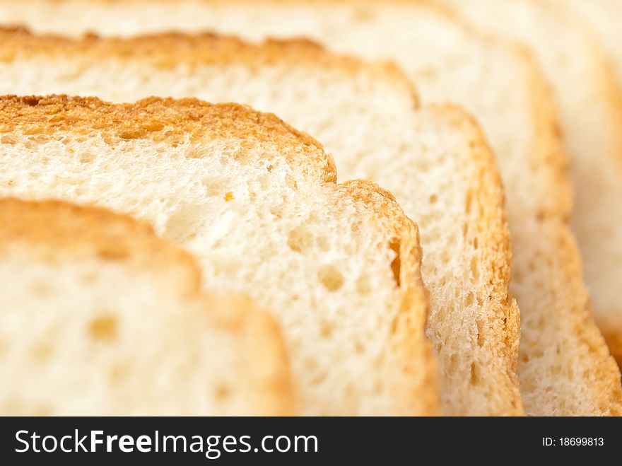 Row of slices of wheaten bread, closeup. Row of slices of wheaten bread, closeup