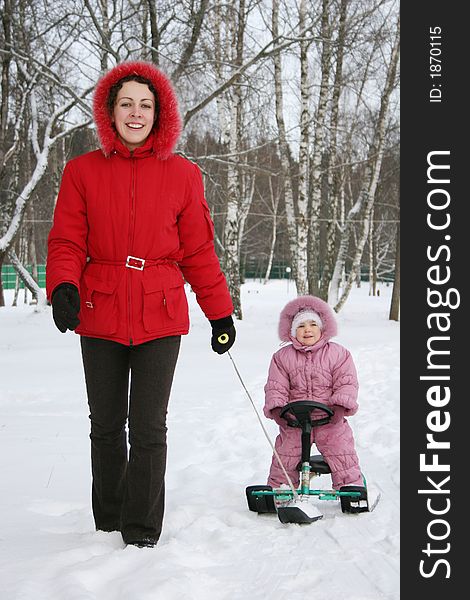 Mother with baby on sled