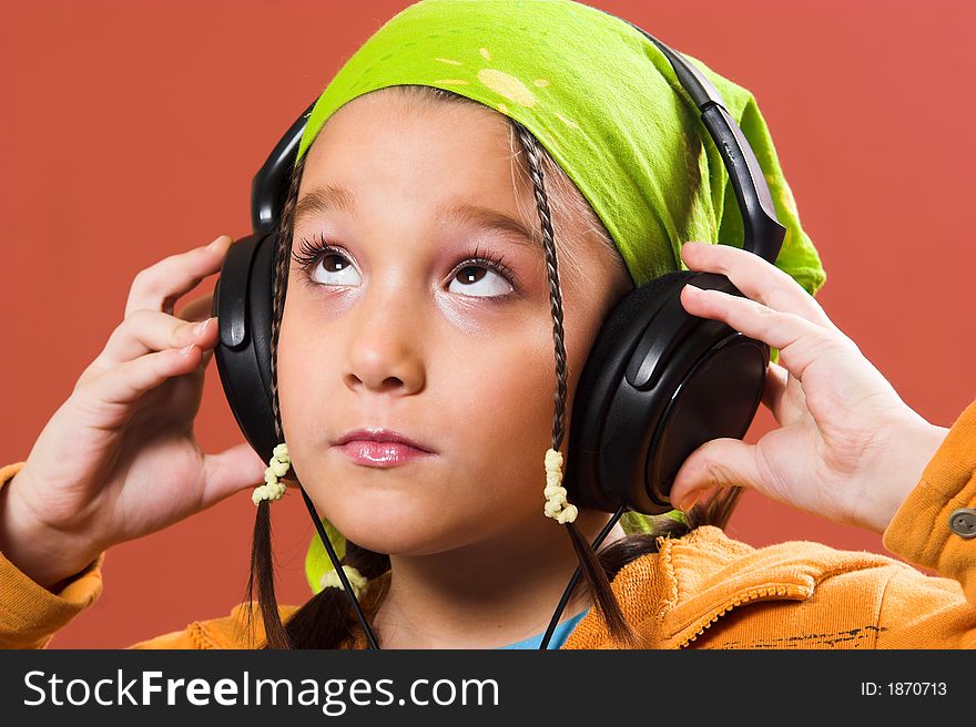 Little pretty child listening music in headphones