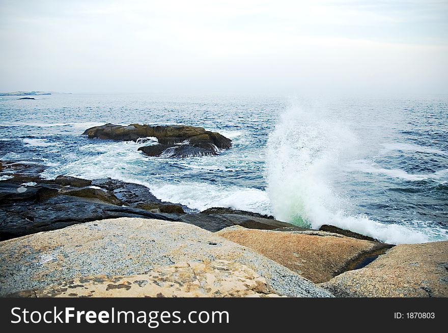 Choppy waves and seaspray on a hazy coast. Choppy waves and seaspray on a hazy coast.