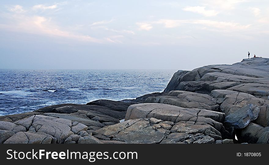 Huge rocks on the coast that dwarf the tourists. Huge rocks on the coast that dwarf the tourists.