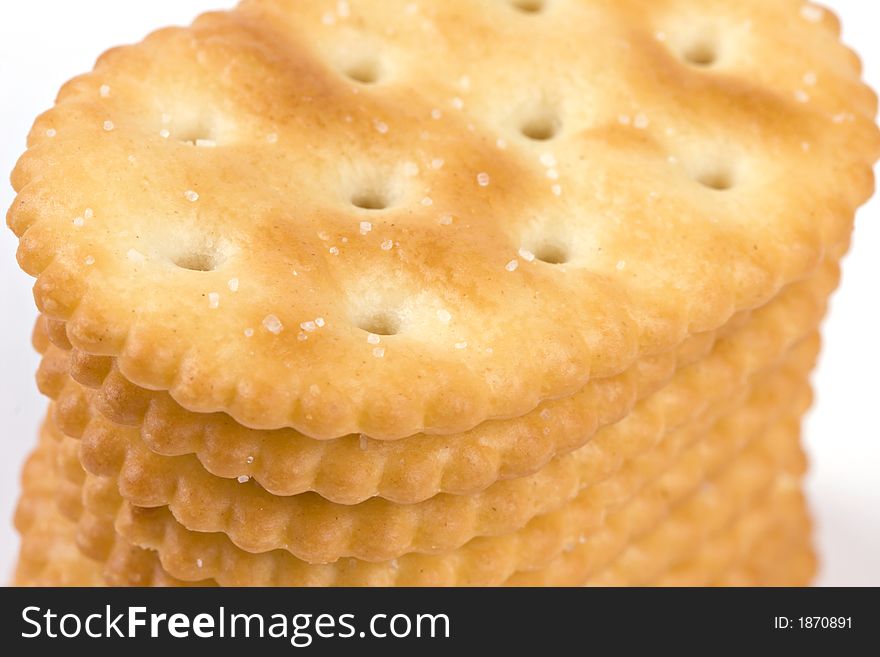 Macro of stack of salted crackers revealing texture and detail isolated on white. Macro of stack of salted crackers revealing texture and detail isolated on white