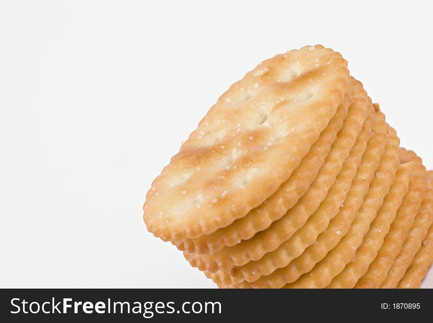 Stack of salted crackers revealing texture and detail isolated on white with room for text. Stack of salted crackers revealing texture and detail isolated on white with room for text