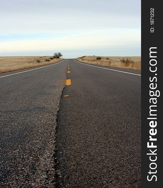 A straight paved road with an incline.