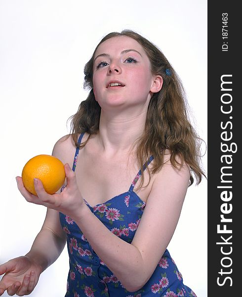 The girl wich is throwing an orange