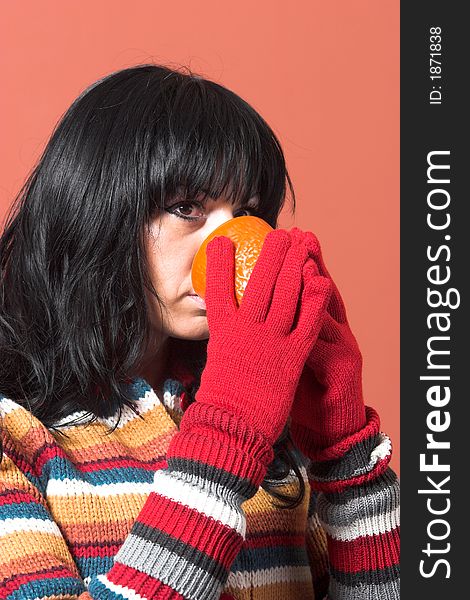 Beautiful woman in sweater dress with orange cup of tea