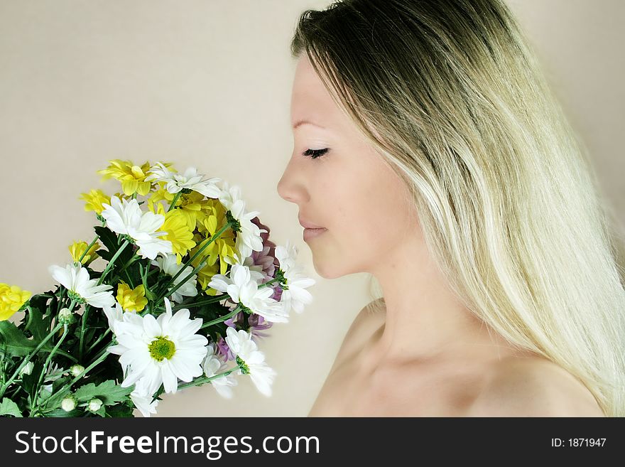 Portrait of a fresh, beautiful young blond woman with some flowers in her hand - valentine ´s day. Portrait of a fresh, beautiful young blond woman with some flowers in her hand - valentine ´s day