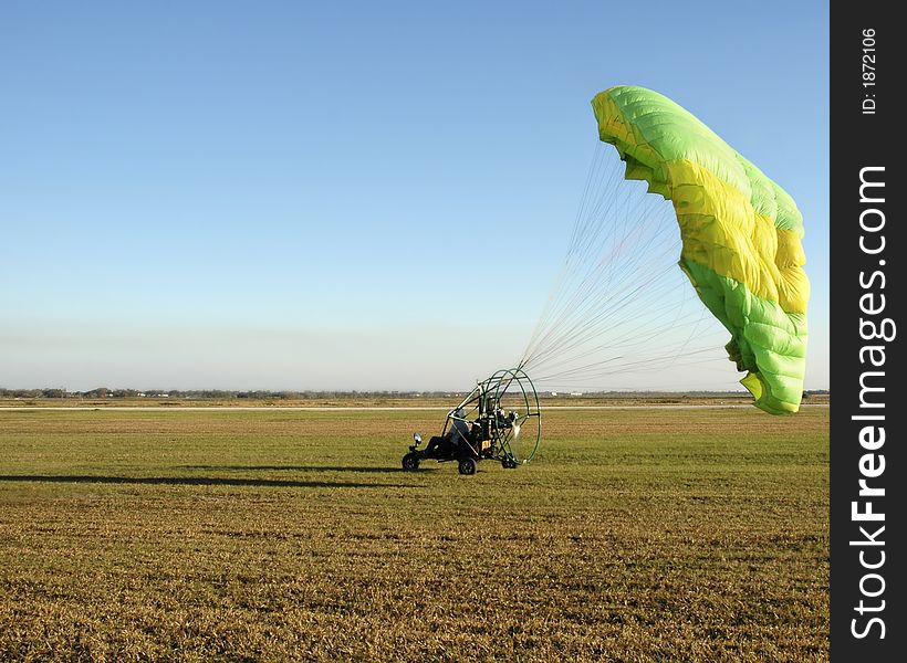 Paraglider touching down after a flight. Paraglider touching down after a flight.