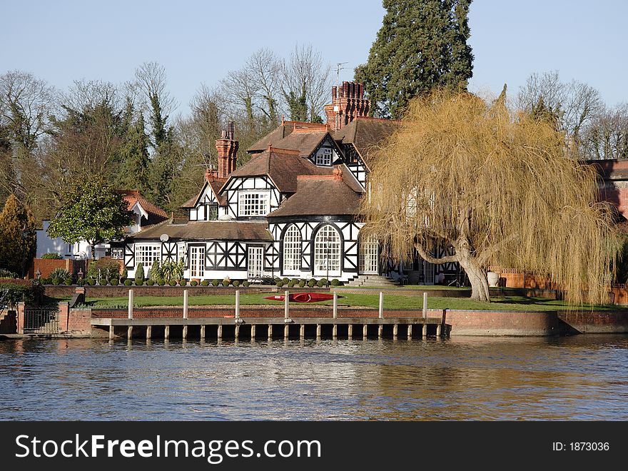 Winter scene of a Luxurious Timber Framed House on the banks of a River in England. Winter scene of a Luxurious Timber Framed House on the banks of a River in England