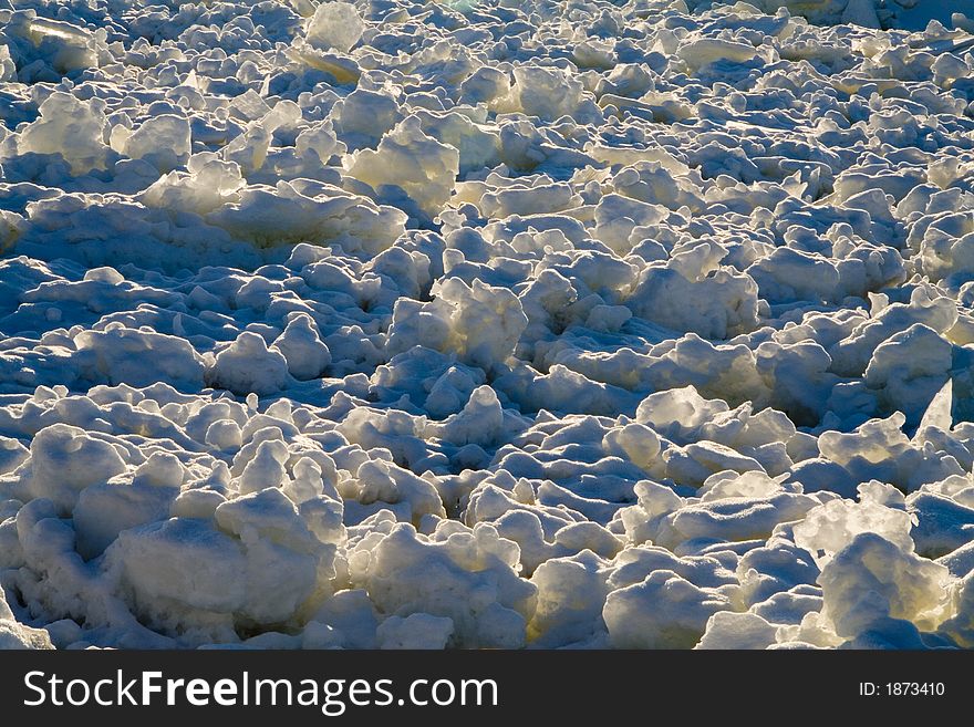 Close-up of chaotic ice floe and snow floating on a river. Close-up of chaotic ice floe and snow floating on a river