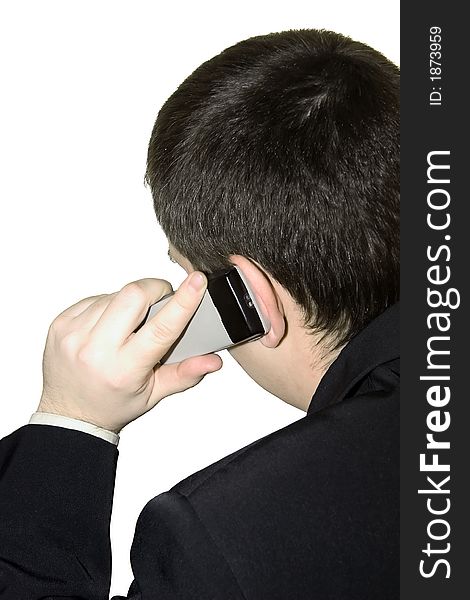 A young man talking on a cellular phone on a white background