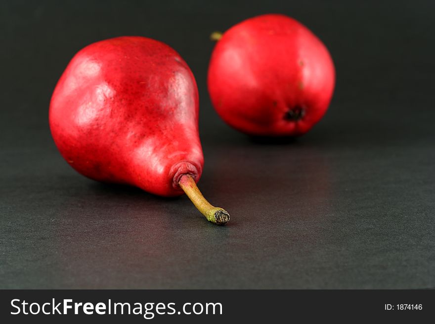 Red pears on dark background, narrow focus