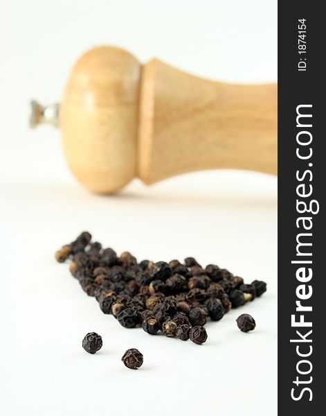 Black pepper corns with peppermill, narrow focus. Black pepper corns with peppermill, narrow focus