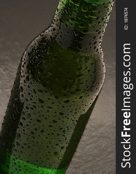 A moody shot of a bottle of beer. A moody shot of a bottle of beer