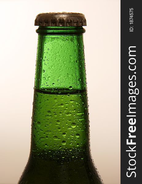 A shot of the neck of a cold bottle of beer. A shot of the neck of a cold bottle of beer