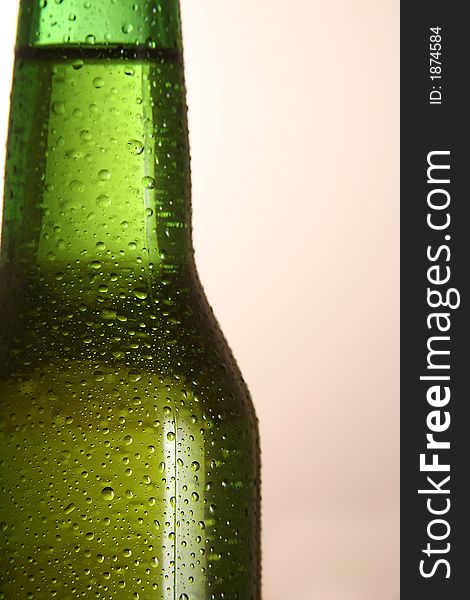 The neck of a cold bottle of beer. The neck of a cold bottle of beer