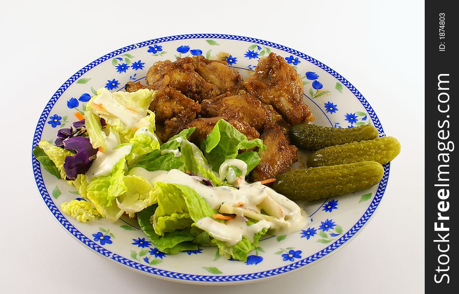 Photo of chicken bbq on a plate together with salad and dressing. Photo of chicken bbq on a plate together with salad and dressing