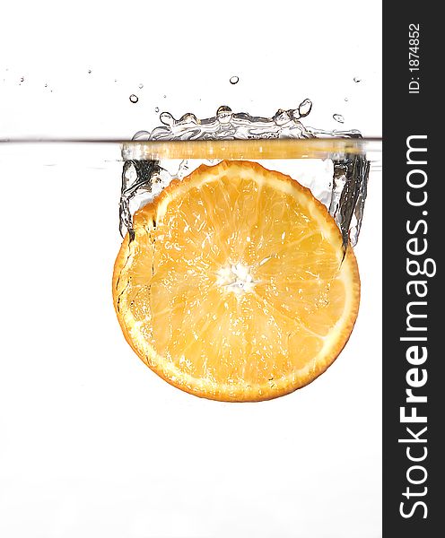 Image of fresh orange slice plunged into water. Image of fresh orange slice plunged into water.