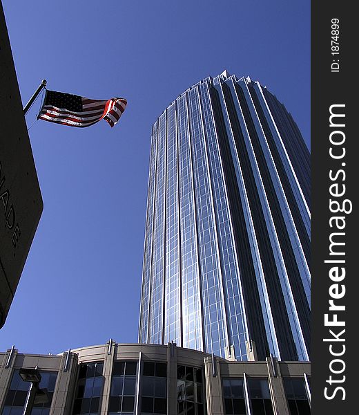 Downtown Boston skyscraper with blue sky background and Old Glory