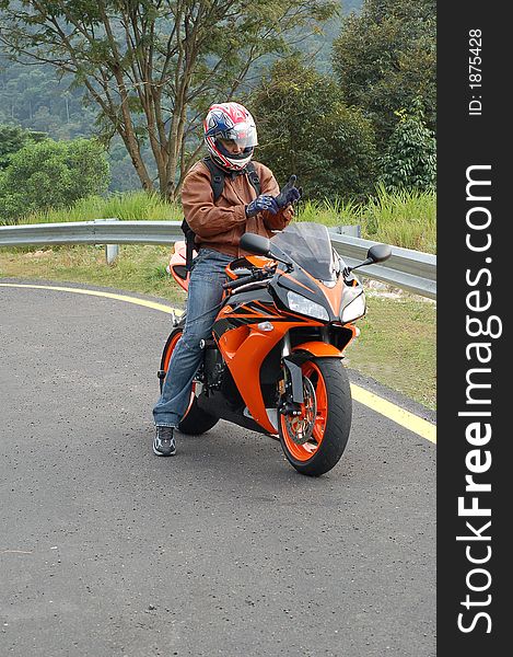 Biker ready tp speed off in full protection gear. Biker ready tp speed off in full protection gear