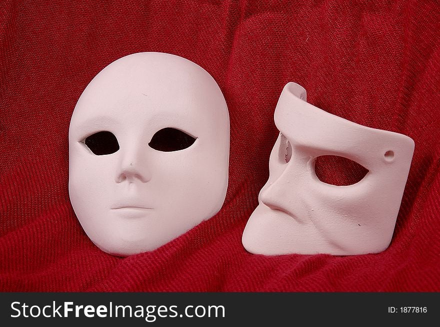 Couple of Venice carnival mask on red sheet