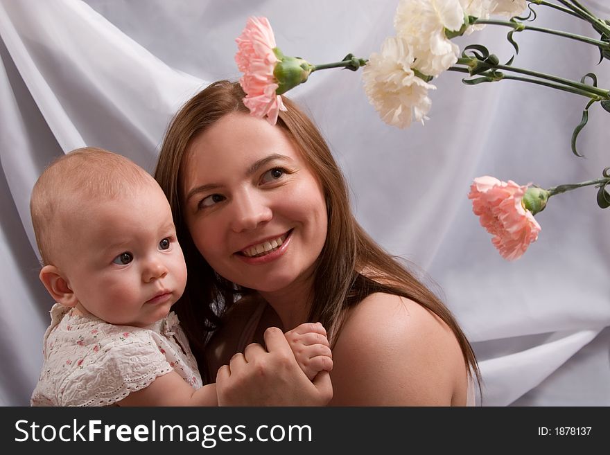 Happy young mother with her little daughter and flowers. Happy young mother with her little daughter and flowers